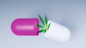 a pill broken in half with a cannabis branch coming out of it