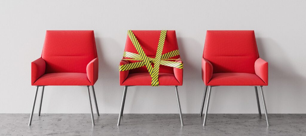 Three red chairs in barrier tape social distancing