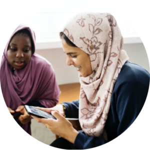 Muslim women looking at a phone