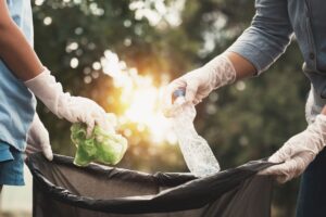 Two people cleaning up litter