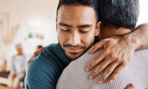 Shot of a father and son hugging at home |