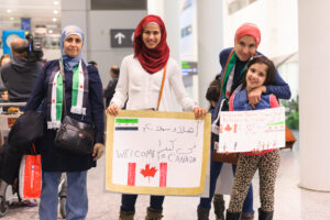 Toronto, Canada - December 11, 2015: Sponsors, family, and Canadians simply wishing to welcome their new neighbours await the first plane's arrival of Syrian refugees at Toronto's Pearson International Airport. |
