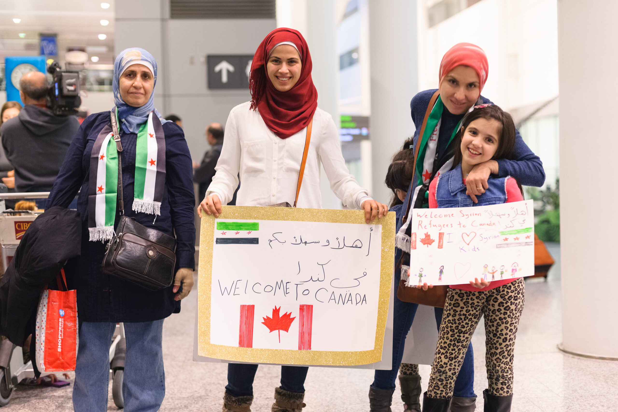 Toronto, Canada - December 11, 2015: Sponsors, family, and Canadians simply wishing to welcome their new neighbours await the first plane's arrival of Syrian refugees at Toronto's Pearson International Airport. |