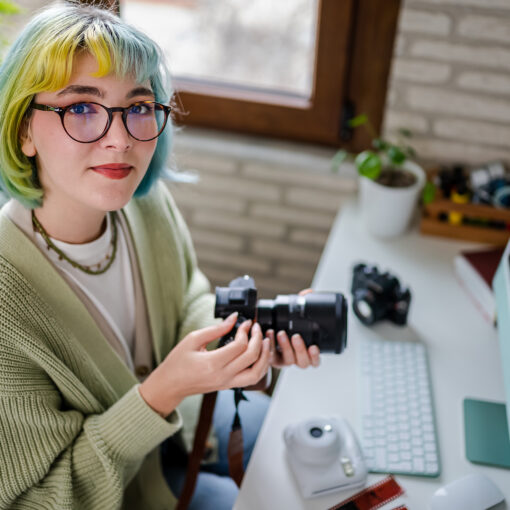 Millennial photographer working on her photos at home office