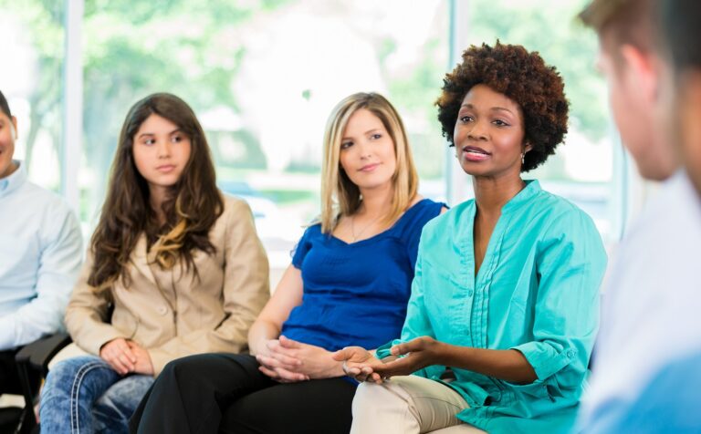 woman speaking during group therapy