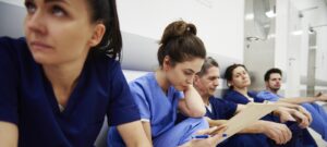 Female nurse examining medical records in the corridor