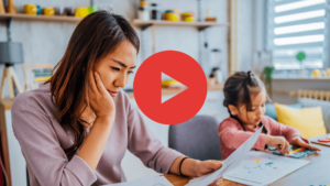 A person looking at bills with a child