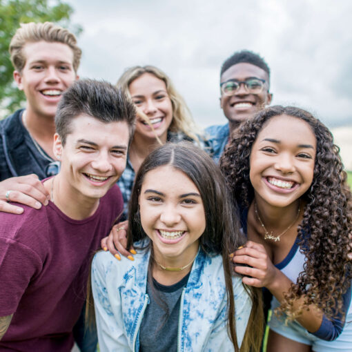 Un groupe de personnes dans un parc, souriant à la caméra