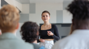 A woman presenting to her peers