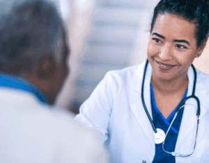 A young doctor smiling at a patient