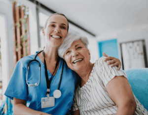 A doctor and patient smile at the camera
