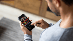 A man staring at a gambling app on his phone