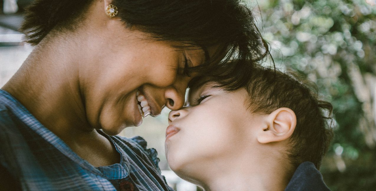 Mom and song affectionately bump heads